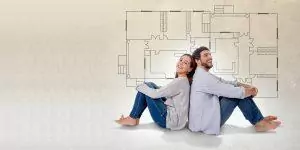 Young couple dreaming and imaging their new house in real state
